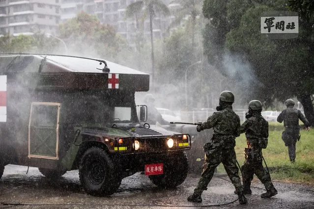 A handout photo made available by the Taiwan Ministry of National Defense, shows Military personnel spraying chemical to a military vehicle during the Biological and Chemical warfare drill in Tainan city, Taiwan, 13 September 2021. The drill is part of the Taiwan’s annual Han Kuang military exercise that simulates response to enemy air-strikes on major targets in Taiwan. (Photo by EPA/EFE)