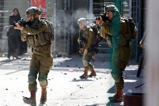 Israeli soldiers shoot rubber bullets at Palestinians during clashes following the death of Palestinian prisoner Khader Adnan during a hunger strike in an Israeli jail, in Hebron in the Israeli-occupied West Bank on May 2,2023. (Photo by Mussa Issa Qawasma/Reuters)