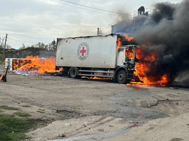 This handout photograph taken and released by the National Police of Ukraine on September 12, 2024, shows a burning trucks of the International Committee of the Red Cross, following an artillery shelling in the Donetsk region, amid the Russian invasion in Ukraine. The International Committee of the Red Cross (ICRC) confirmed on September 12, 2024 that three staff members were killed by shelling in eastern Ukraine, after Kyiv announced a Russian attack had struck the organisation's vehicles. (Photo by National Police of Ukraine/AFP Photo)