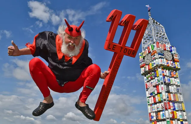 Bicycle designer Dieter “Didi” Senft wears a “Tour Devil” costume as he presents his latest bicycle creation in Storkow, Germany,  July 1, 2014. Senft has created a bicycle in the shape of London's Big Ben from 387 drinking bottles on the occasion of this year's Tour de France that starts on 05 July. Senft has been working on extraordinary bike designs for years and holds numerous world records. (Photo by Patrick Pleul/EPA)