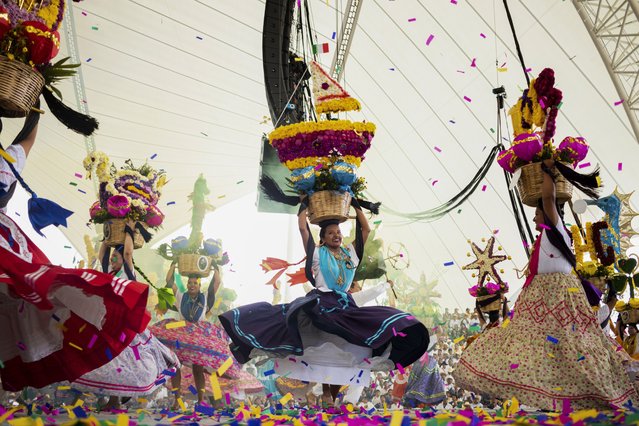 Dancers perform on the first day of the Guelaguetza in Oaxaca, Mexico, Monday, July 17, 2023. During the government-sponsored event, 16 Indigenous ethnic groups and the Afro-Mexican community promote their traditions through public dances, parades and craft sales. (Photo by Maria Alferez/AP Photo)