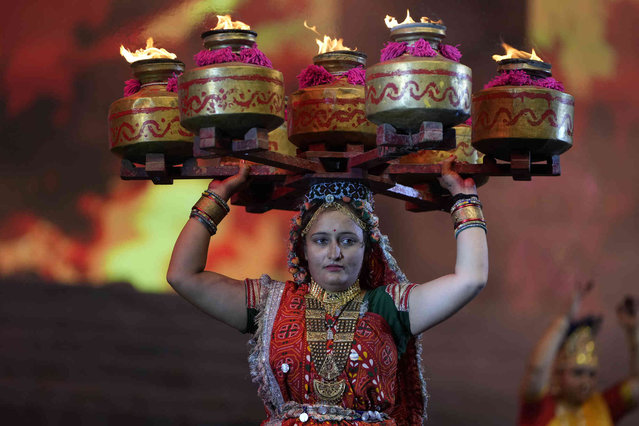 Artists performs during an inauguration of Navratri or nine night festival, which begins today in Ahmedabad, India, Thursday, October 3, 2024. (Photo by Ajit Solanki/AP Photo)