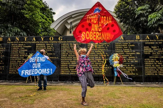 Elderly activists fly kites bearing slogans as relatives and friends of martial law victims, as well as human rights activists, gather at the Bantayog ng mga Bayani (Monument of Heroes), a park dedicated to preserving the memory of Marcos martial law victims, to mark Independence Day on June 12, 2022 in Quezon city, Metro Manila, Philippines. The gathering drew relatives and friends of those who fought and died during the Marcos martial law years. The ousted dictator Ferdinand Marcos Sr. was accused and charged of amassing billions of dollars of ill-gotten wealth as well as committing a record number of human rights abuses during his autocratic rule. His son, Ferdinand “Bongbong” Marcos Jr., was elected president of the Philippines by a landslide vote on May 9, 2022. (Photo by Ezra Acayan/Getty Images)