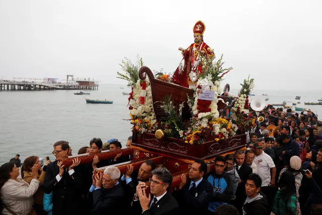 Peruvians commemorate the Day of the Fisherman by taking a statue of Saint Peter out on a boat along the coast in Lima June 29, 2016. (Photo by Guadalupe Pardo/Reuters)