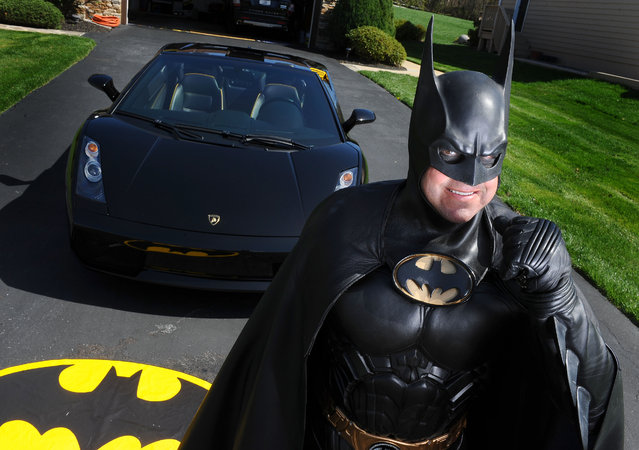 In this March 27, 2012, photo, Leonard Robinson, dressed as Batman, poses for a photo outside his home, in Owings Mills, Md. Authorities say, Robinson, known for visiting hospitalized children dressed in his Batman costume, died, Sunday, August 16, 2015, in a crash on Interstate 70, in western Maryland. (Photo by Jonathan Newton/The Washington Post via AP Photo)