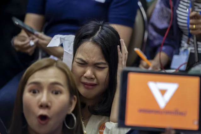 Supporters of Thailand's Future Forward Party react as they watch a live television broadcast of a court verdict at their party's headquarters in Bangkok, Thailand, Friday, February 21, 2020. Thailand's Constitutional Court on Friday ordered the popular opposition Future Forward Party dissolved, declaring that it violated election law by accepting a loan from its leader. The court also imposed a 10-year ban on the party's executive members holding political office. (Photo by Gemunu Amarasinghe/AP Photo)