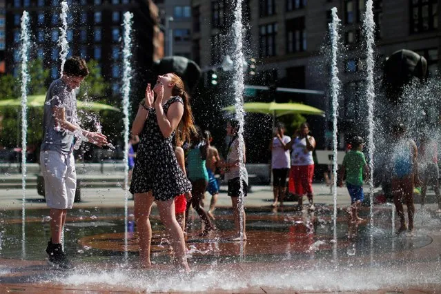 People cool off in fountain on the Rose Kennedy Greenway on summer afternoon in Boston, Massachusetts, U.S. June 21, 2016. (Photo by Brian Snyder/Reuters)