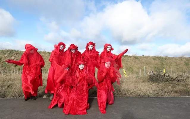 The Red Brigade performers attend the Extinction Rebellion protest at Banks Group's open-cast coal mine in Bradley, County Durham, Britain on February 26, 2020. (Photo by Scott Heppell/Reuters)