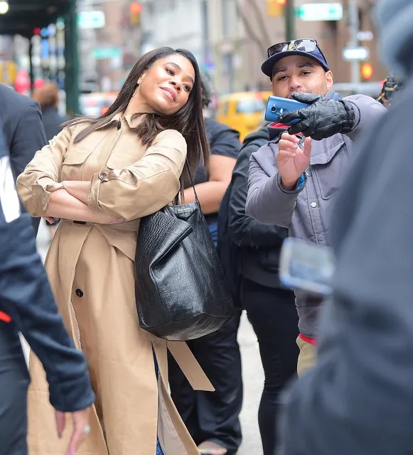 Regina Hall pours on the hand sanitizer after taking long distance selfies with fans in NYC amid massive closures due to the coronavirus on March 12, 2020. (Photo by DIGGZY/Splash News and Pictures)