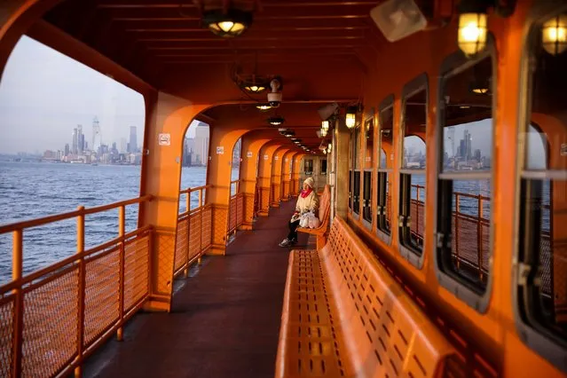 A commuter enjoys the sunset alone on the upper deck of a Staten Island Ferry during the outbreak of the coronavirus disease (COVID-19) in Manhattan, New York City, U.S., March 26, 2020. (Photo by Caitlin Ochs/Reuters)