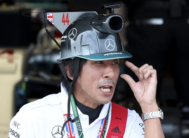 A Mercedes fan waits for the start of the third practice session for the Japanese Formula One Grand Prix at Suzuka, Japan, Saturday, October 7, 2017. (Photo by Eugene Hoshiko/AP Photo)