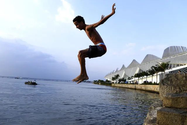 Gabriel Luiz, 16, jumps into the Guanabara Bay near the new  Museum of Tomorrow on August 2, 2016 in Rio De Janeiro, Brazil. (Photo by Jonathan Newton/The Washington Post)