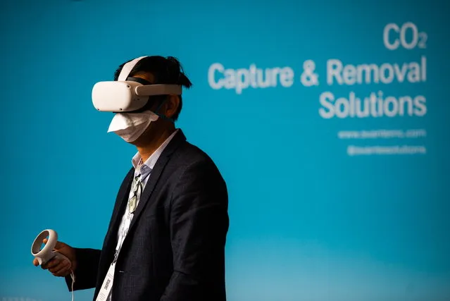 An attendee explores a carbon capture facility in virtual reality during the Global Clean Energy Action Forum held at the David L Lawrence Convention Center in Pittsburgh, Pennsylvania, USA, 23 September 2022. The Forum, hosted by the US Department of Energy, brings together thousands of attendees, government representatives and more than 300 CEOs to “advance the implementation of clean energy deployment and innovation”. (Photo by Shane Dunlap/EPA/EFE)