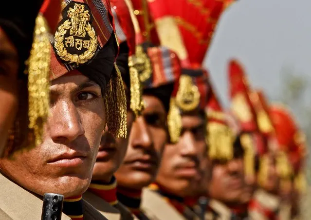 New recruits of the Indian Border Security Force stand during their passing out parade ceremony in Humhama, on the outskirts of Srinagar, India, on October 11, 2012. 244 recruits formally inducted into the force, will join Indian soldiers fighting separatist Islamic guerrillas in Kashmir to help end an insurgency that started in 1989. (Photo by Mukhtar Khan/Associated Press)