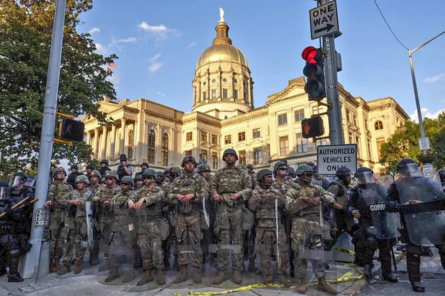Authorities stand guard in the area around the Georgia state Capitol as protests continued for a third day in Atlanta on Sunday, May 31, 2020. Protests were held in U.S. cities over the death of George Floyd, a black man who died after being restrained by Minneapolis police officers on May 25. (Photo by Ben Gray/Atlanta Journal-Constitution via AP Photo)
