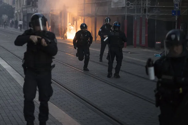 Police advance on protesters during a march against police brutality and racism in Marseille, France, Saturday, June 13, 2020, organized by supporters of Adama Traore, who died in police custody in 2016 in circumstances that remain unclear despite four years of back-and-forth autopsies. Several demonstrations went ahead Saturday inspired by the Black Lives Matter movement in the U.S. (Photo by Daniel Cole/AP Photo)