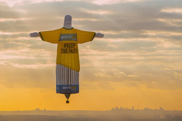 A balloon shaped in the famous 'Christ the Redeemer' statue that overlooks the Brazilian city of Rio de Janeiro floats at sunrise as part of an advertisement campaign for an online betting company above the Australian city of Sydney November 13, 2017. (Photo by Steve Christo/Reuters)