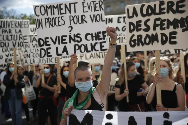 Protesters hold placards reading “how to avoid a rape trial? by becoming police chief“, “women's anger rumbles” during a demonstration called by feminist movements in front of the city hall in Paris, on July 10, 2020, to denounce the nomination of French Interior Minister, facing rape accusations and French Justice Minister who criticised the #MeToo movement against sexual harassment. (Photo by Thomas Coex/AFP Photo)
