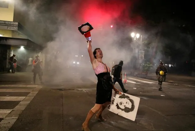A demonstrator reacts during a protest against racial inequality and police violence in Portland, Oregon, U.S., July 28, 2020. (Photo by Caitlin Ochs/Reuters)