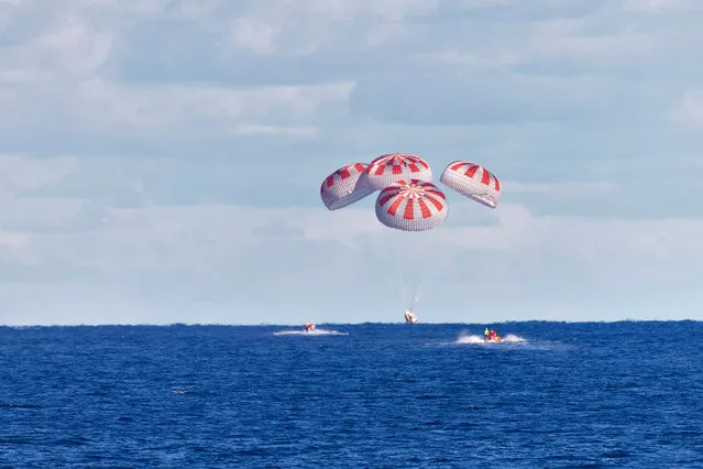 The SpaceX capsule splashes down Sunday, August 2, 2020, in the Gulf of Mexico. Astronauts Doug Hurley and Bob Behnken spent a little over two months on the International Space Station. It s the first splashdown in 45 years for NASA astronauts and the first time a private company has ferried people from orbit. (Photo by Cory Huston/NASA via AP Photo)