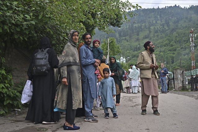 Indian villagers wait for transportation as they evacuate following overnight Pakistani artillery shelling in Uri, about 100kms from Srinagar, on May 9, 2025. India said on May 9 it had repulsed a wave of Pakistani drone and artillery attacks overnight, and Islamabad insisted it had not struck targets across the border, as the latest conflict between the nuclear-armed neighbours showed no signs of relenting. (Photo by Tauseef Mustafa/AFP Photo)