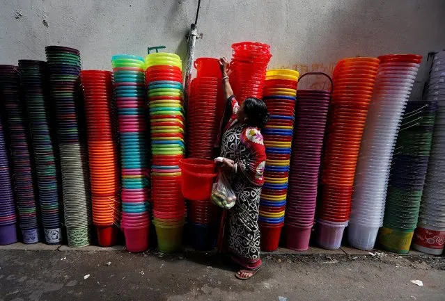 A woman shops for plastic buckets at a roadside shop in Kolkata, India, September 21, 2016. (Photo by Rupak De Chowdhuri/Reuters)