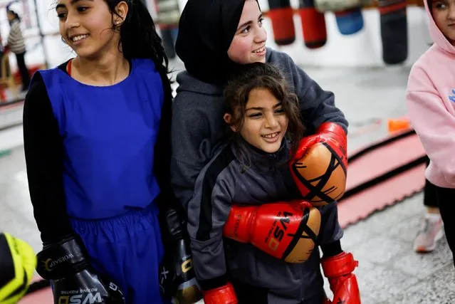 Palestinian girl boxers stand inside the first women boxing center in Gaza City on January 17, 2023. (Photo by Mohammed Salem/Reuters)