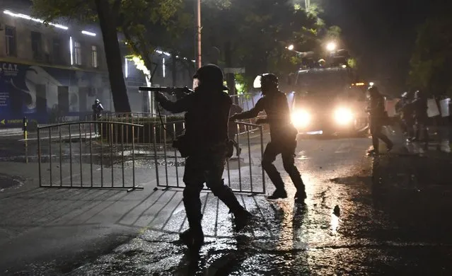 Riot police disperse protesters during a rally against the results of a parliamentary vote in Bishkek, Kyrgyzstan, Monday, October 5, 2020. (Photo by Vladimir Voronin/AP Photo)