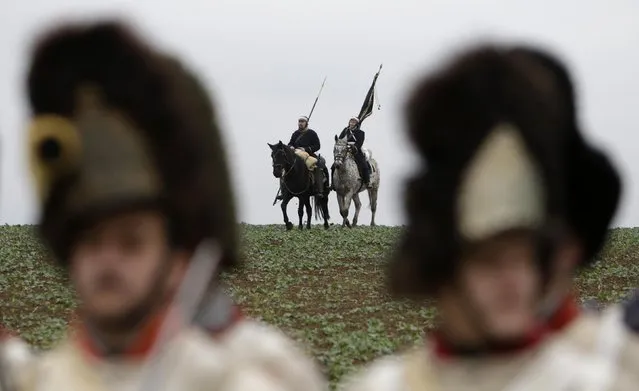 Historical re-enactment enthusiasts dressed as soldiers ride horses near the southern Moravian village of Herspice November 28, 2014. (Photo by David W. Cerny/Reuters)