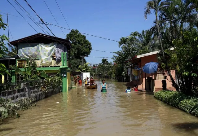 Residents travel across floodwaters a week after typhoon Koppu battered Calumpit town, Bulacan province, north of Manila October 24, 2015. (Photo by Romeo Ranoco/Reuters)