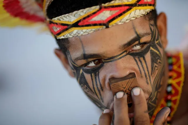 An indigenous man from the Pataxo tribe waits for a trial on the demarcation of indigenous lands, according to local media, in Brasilia, Brazil March 1, 2018. (Photo by Ueslei Marcelino/Reuters)