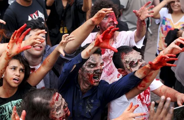 Revellers with their bodies and faces painted attend the "Zombie Walk" parade in Sao Paulo, Brazil, November 2, 2015. (Photo by Paulo Whitaker/Reuters)