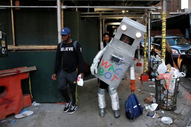 A man dressed as Wac Bot walks under scaffolding toward New York Comic Con in Manhattan, New York, U.S., October 7, 2016. (Photo by Andrew Kelly/Reuters)