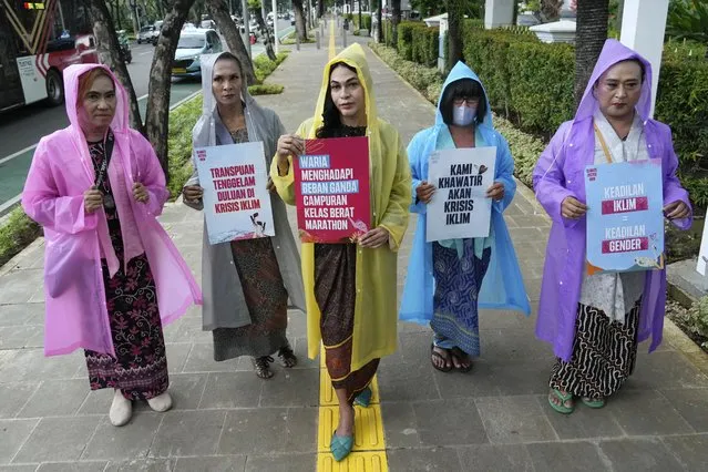 Environmental activists hold posters during a protest calling for the government to take immediate action against climate change in Jakarta, Indonesia, March, 3, 2023. (Photo by Achmad Ibrahim/AP Photo)