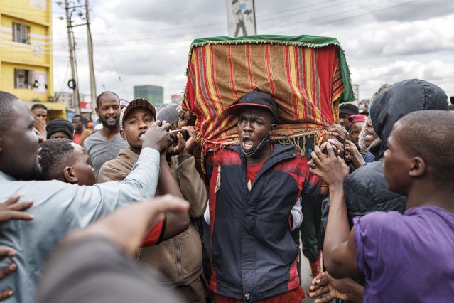 Family, friends and fellow protesters carry the body of Ibrahim Kamau, 19, in a procession as they chant slogans to show their respects in the streets of Nairobi, on June 28, 2024. Hundreds of people attended the funeral ceremony of Ibrahim Kamau, 19, who was one of the protesters killed at the Kenyan Parliament during the nationwide deadly protest against a controversial now-withdrawn tax bill that left over 20 dead and shocked the East African nation. (Photo by Tony Karumba/AFP Photo)