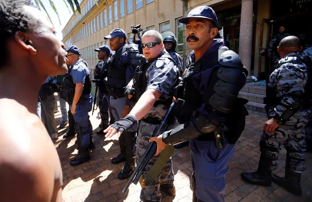 Students at the University of Cape Town confront police and private security officials during protests demanding free tertiary education in Cape Town, South Africa, October 17, 2016. (Photo by Mike Hutchings/Reuters)