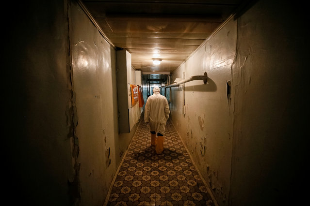 An employee walks through the corridor of the stopped third reactor at the Chernobyl nuclear power plant in Chernobyl, Ukraine April 20, 2018. (Photo by Gleb Garanich/Reuters)