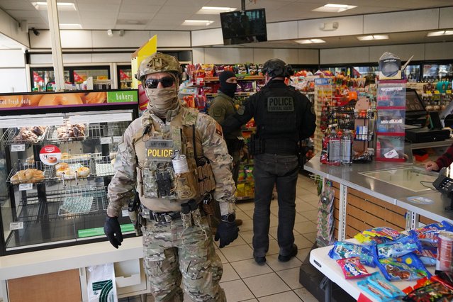 Federal agents walks through a gas station while searching for undocumented immigrants on November 17, 2025 in Charlotte, North Carolina. Federal agents are carrying out “Operation Charlotte's Web”, an ongoing immigration enforcement surge across the Charlotte region (Photo by Ryan Murphy/Getty Images)