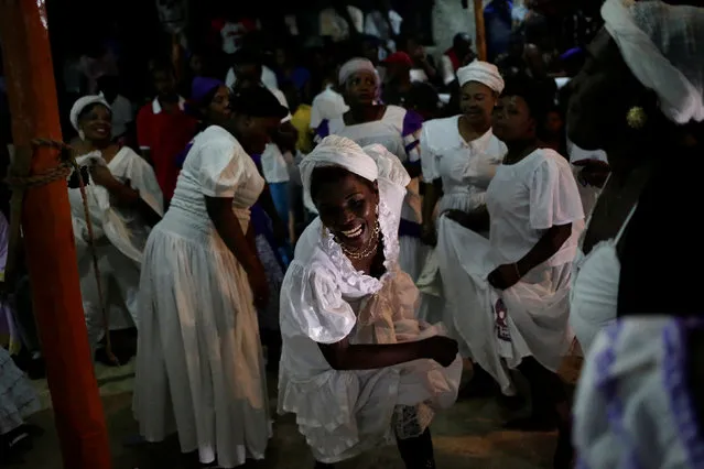 A voodoo believer laughs as she dances during a ceremony of Fet Gede in a Peristil, a voodoo temple, in Port-au-Prince, Haiti, November 1, 2016. (Photo by Andres Martinez Casares/Reuters)