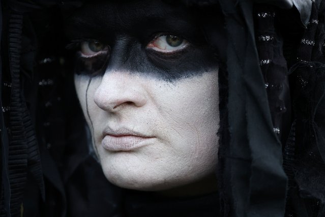 An activist of “Extinction Rebellion” (XR) dressed as an oil slick, attends a protest, in Windsor, Britain, on August 30, 2024. (Photo by Mina Kim/Reuters)