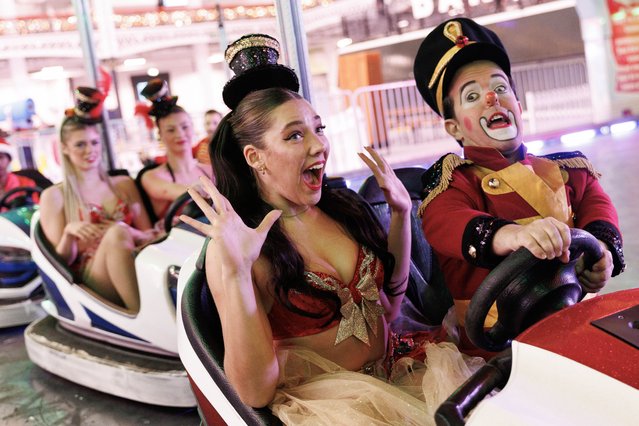 Performers ride the dodgems during a photocall for Winter Funland at Olympia Exhibition Centre on December 12, 2025 in London, England. The festive experience features a Christmas circus, fairground rides, and an ice rink at the indoor events venue in West London, opens 13th December. (Photo by Dan Kitwood/Getty Images)