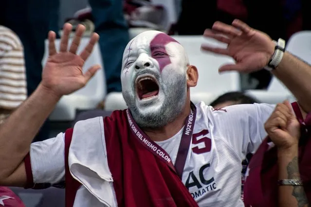 A supporter of Saprissa celebrates after the team won the Costa Rican football final by defeating Liga Deportiva Alajuelense in the second leg match at the Ricardo Saprissa stadium in San Jose, on May 28, 2023. (Photo by Ezequiel Becerra/AFP Photo)