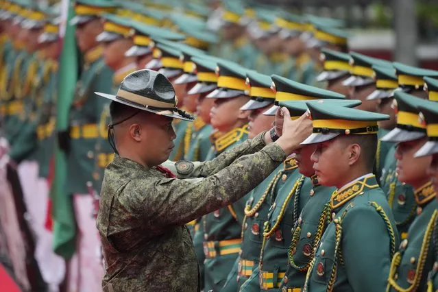 A Philippine Army officer checks on members of an honor guard before the start of arrival honors for United States Army Chief of Staff, General James McConville at Fort Bonifacio, Taguig city, Philippines on Wednesday, May 10, 2023. (Photo by Aaron Favila/AP Photo)