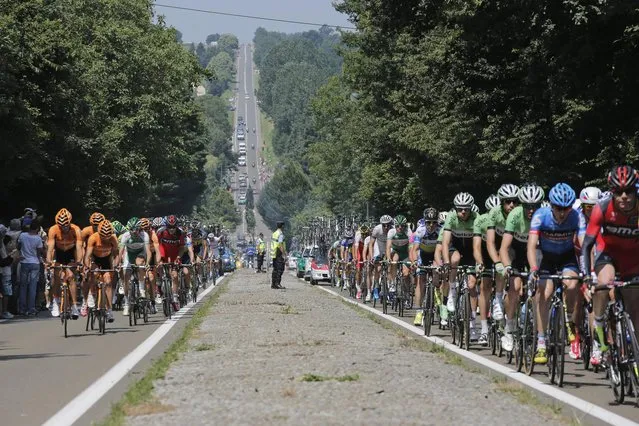 The pack passes during the twelfth stage of the Tour de France cycling race over 218 kilometers (136.2 miles) with start in in Fougeres and finish in Tours, western France, Thursday July 11 2013. (Photo by Christophe Ena/AP Photo)