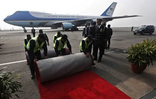 Airport staff rolls back the red carpet upon the departure of U.S. President Barack Obama and first lady Michelle Obama at the Airport in New Delhi January 27, 2015. Obama weighed in on one of India's most sensitive topics as he wound up a visit on Tuesday, making a plea for freedom of religion to be upheld in a country where relations between Hindus and minorities have come under strain. (Photo by Adnan Abidi/Reuters)