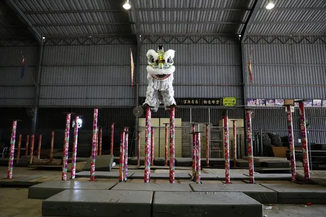 Members of Kun Seng Keng Lion and Dragon Dance Association, demonstrate a traditional Chinese lion dance at a training centre, during an interview with Reuters, in Muar, Malaysia on February 5, 2021. (Photo by Lim Huey Teng/Reuters)