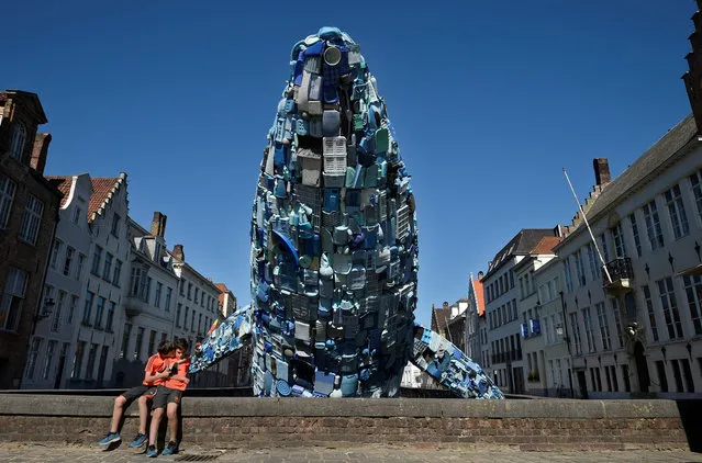 A 12-metre installation depicting a whale, made up of five tons of plastic waste pulled out of the Pacific Ocean, is displayed in Brugges, on July 14, 2018 for the 2018 Bruges Triennial. (Photo by John Thys/AFP Photo)