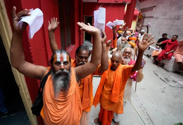 Hindu holy men stand in a queue to register for the annual Amarnath pilgrimage, in Jammu, India, Thursday, June 29, 2023. The Amarnath Yatra pilgrimage is held annually to the holy Amarnath cave, dedicated to Hindu god Shiva. (Photo by Channi Anand/AP Photo)
