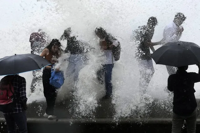People enjoy high tide waves on the Arabian Sea coast in Mumbai, India, Thursday, July 6, 2023. (Photo by Rajanish Kakade/AP Photo)
