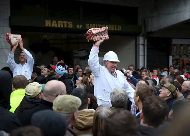 Butchers sell their remaining produce of the year at discounted prices during the traditional Christmas Eve auction at Smithfield's market in London  December 24, 2015. (Photo by Neil Hall/Reuters)